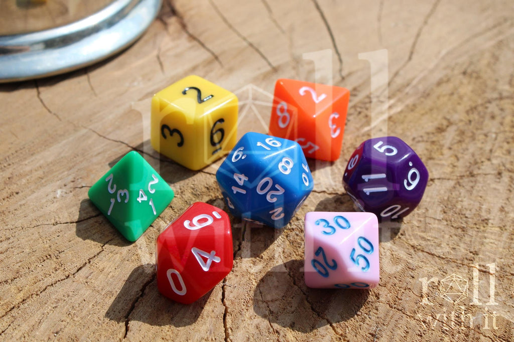A colourful set of rainbow polyhedral roleplaying dice with white, blue, and black numbers on a wooden surface