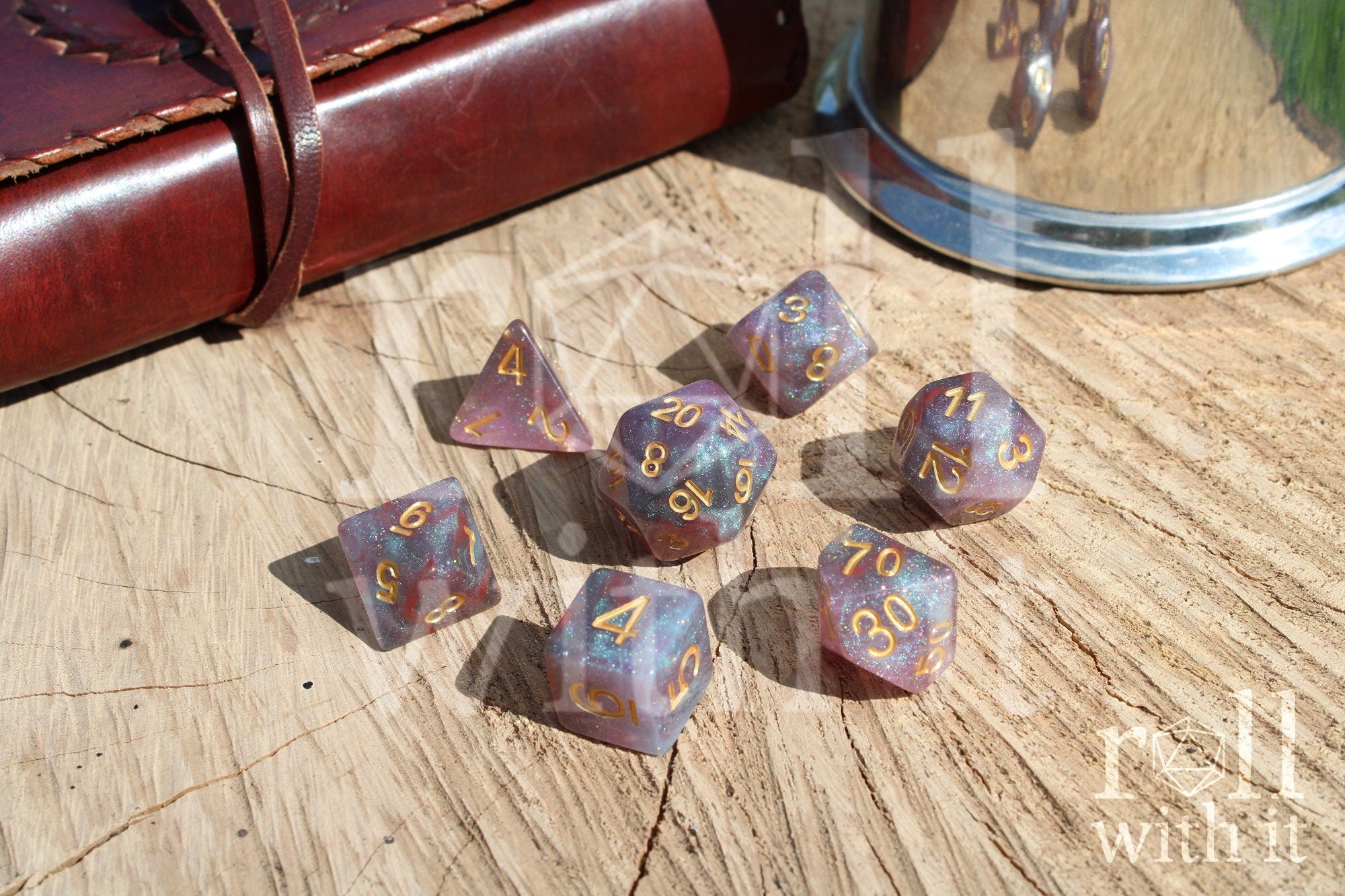 Set of glittery star like purple and blue polyhedral dice on a wooden surface