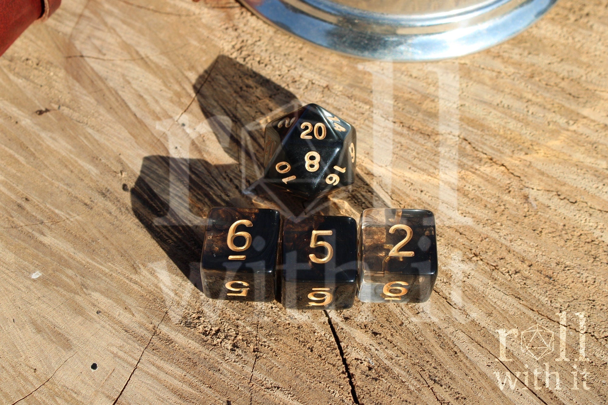 Set of clear and black smoke like polyhedral dice on a wooden surface
