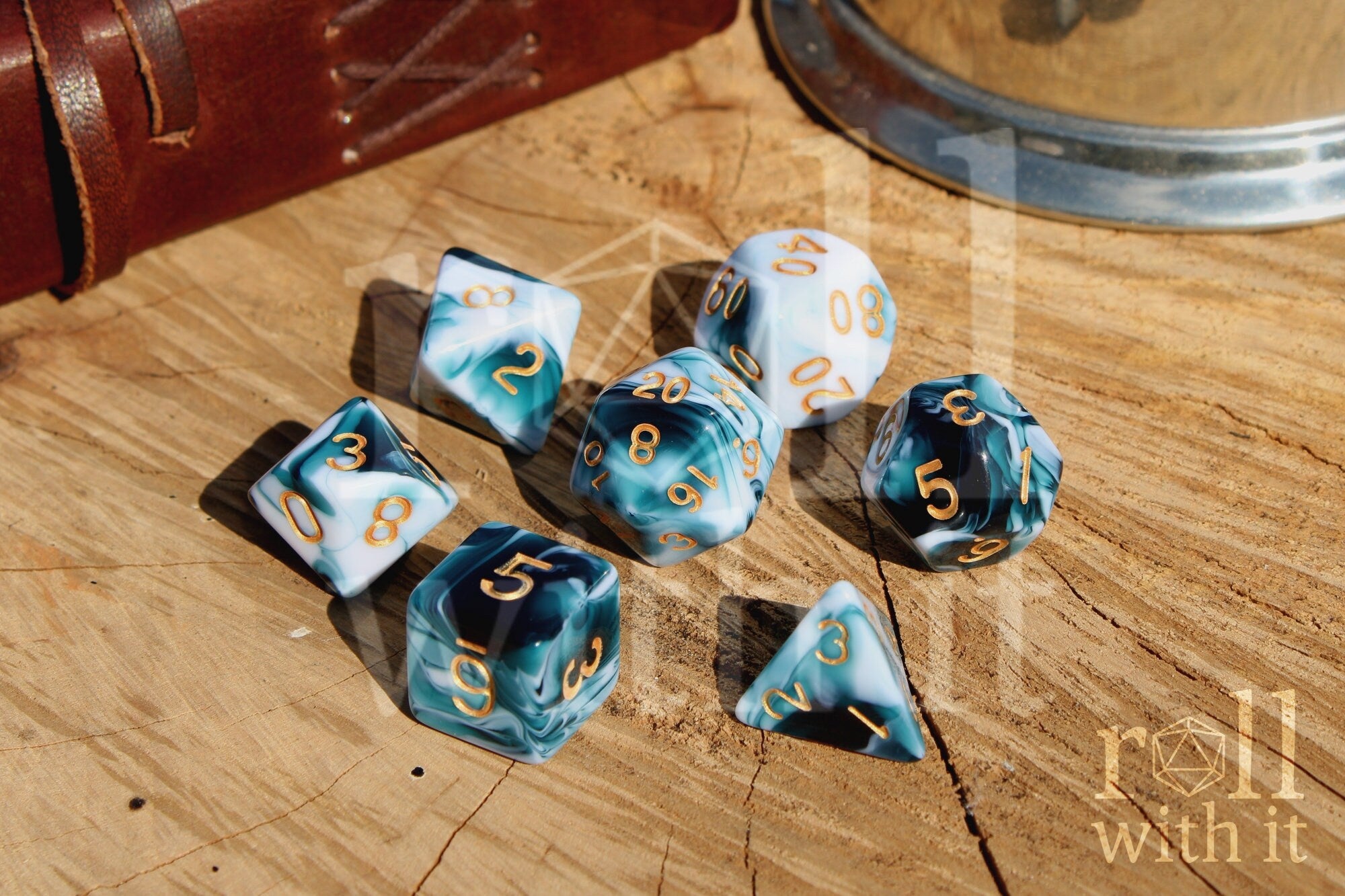 Set of swirling white and blue DnD roleplaying dice with gold numbers on a wooden surface