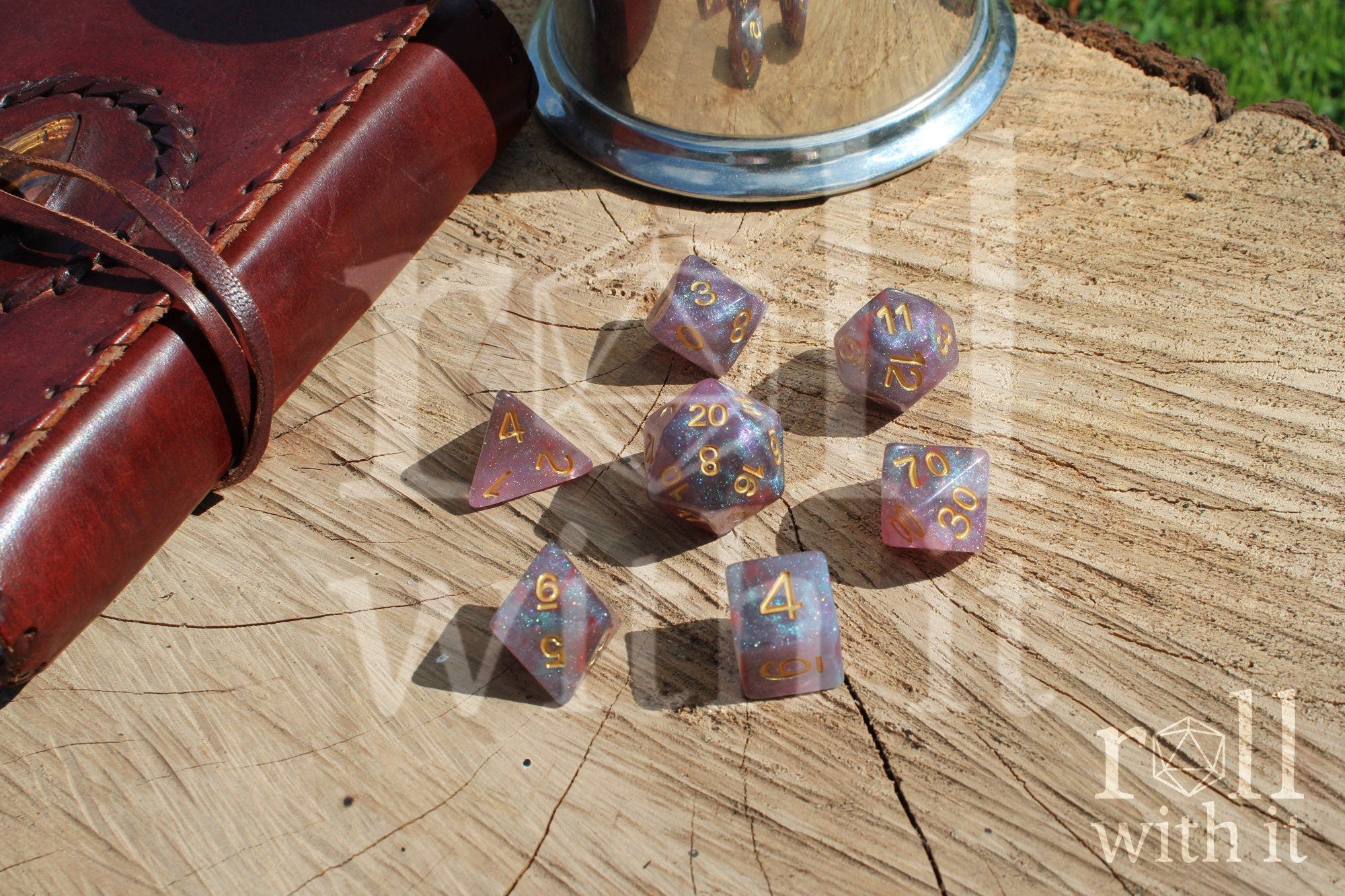 Set of glittery star like purple and blue polyhedral dice on a wooden surface