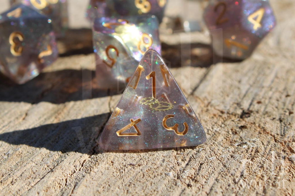 Set of glittery and star like dice with gold numbers and golden cogs inside on a wooden surface