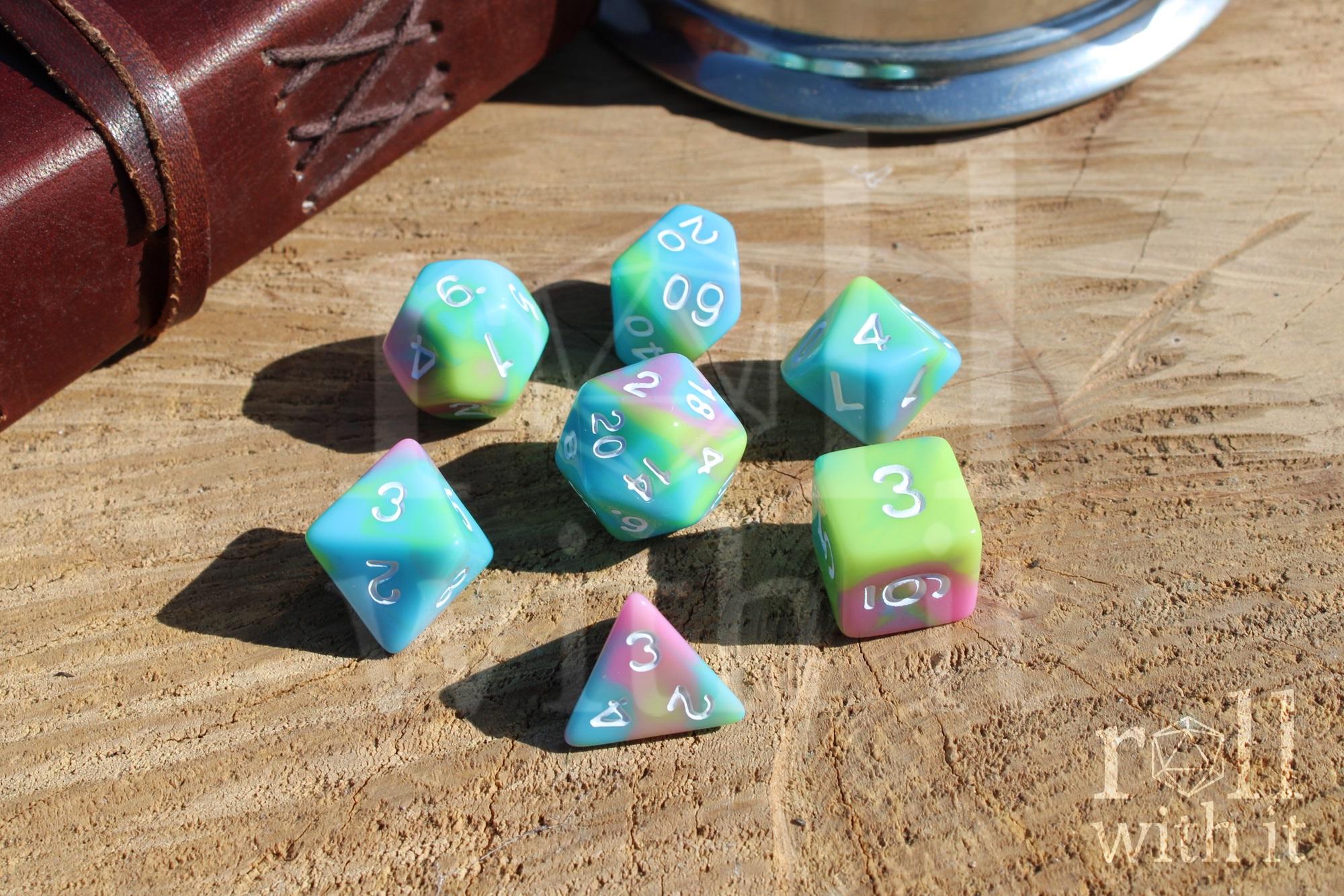 Set of colourful pastel rainbow polyhedral roleplaying dice on a wooden surface