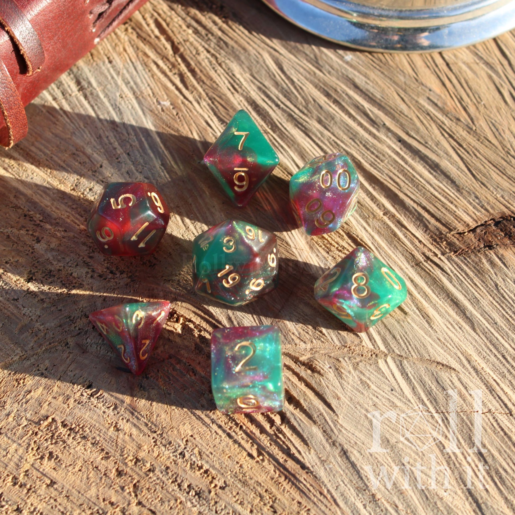 Set of colorful red purple forest green shiny glitter streaks mixed polyhedral dice on a wooden surface