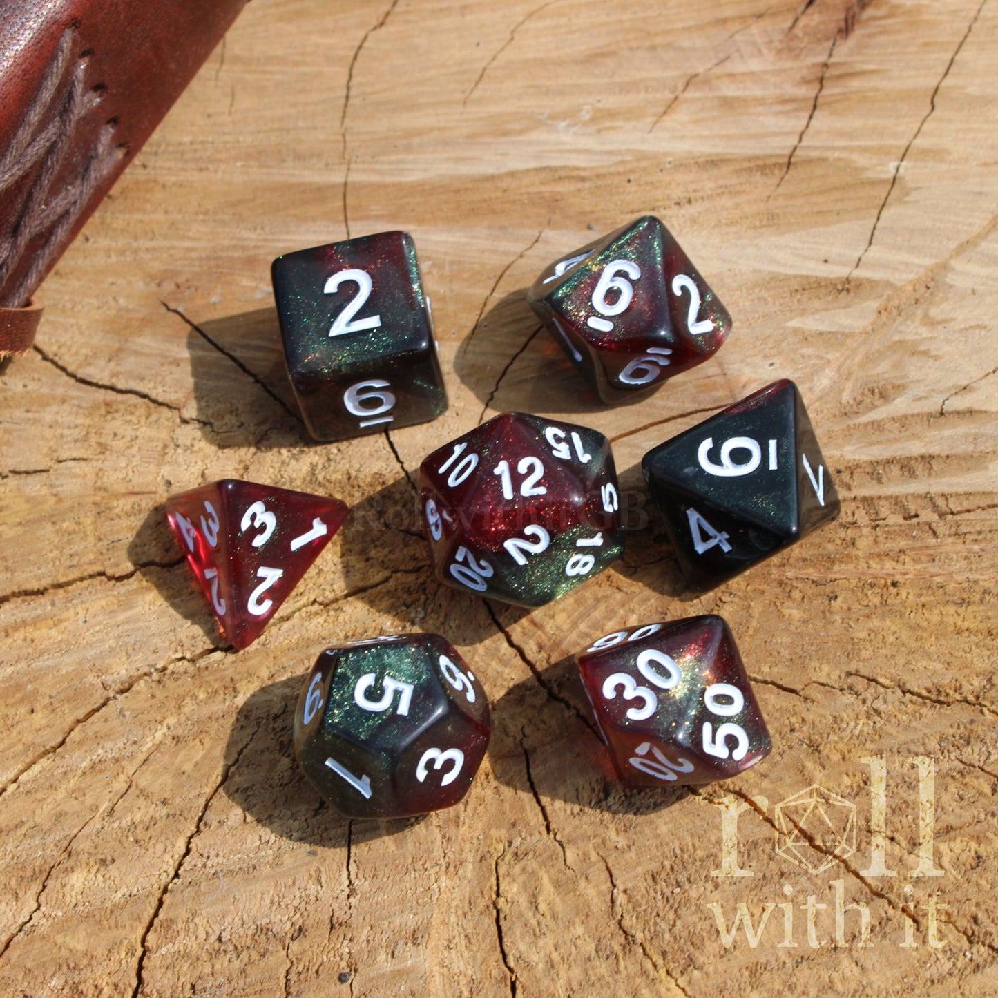 Set of polyhedral dice on a wooden surface