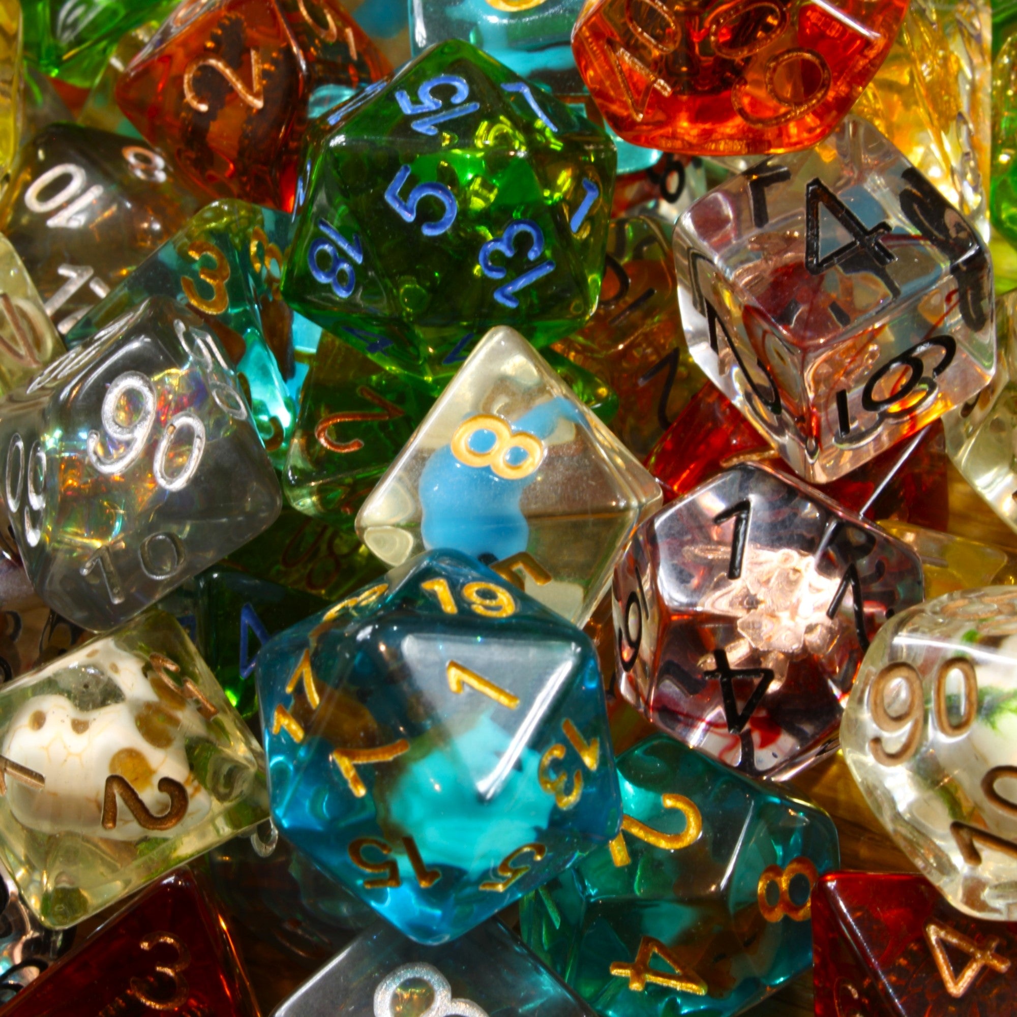 Assorted colourful filled transparent polyhedral roleplaying dice with numbers on a close-up shot