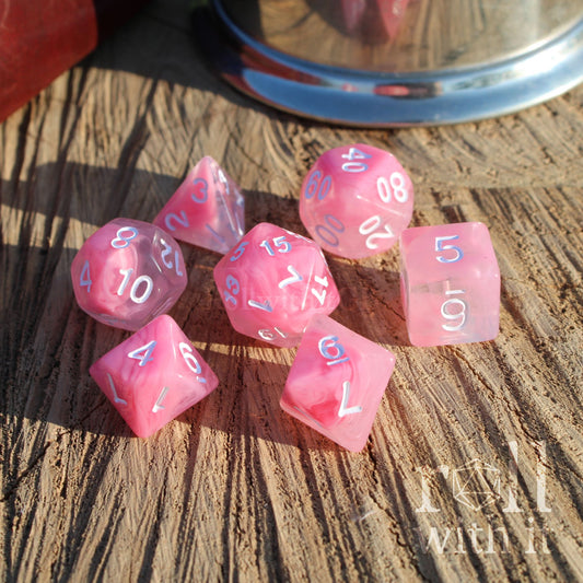 A set of 7 cute pink cloudy aesthetic polyhedral RPG on a wooden surface with white numbers