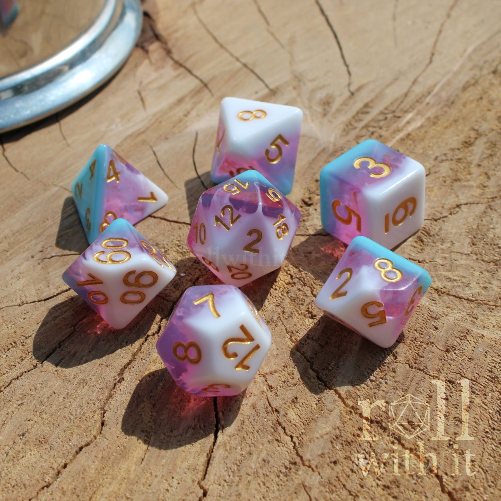 Set of colorful polyhedral dice on a wooden surface with golden numbers