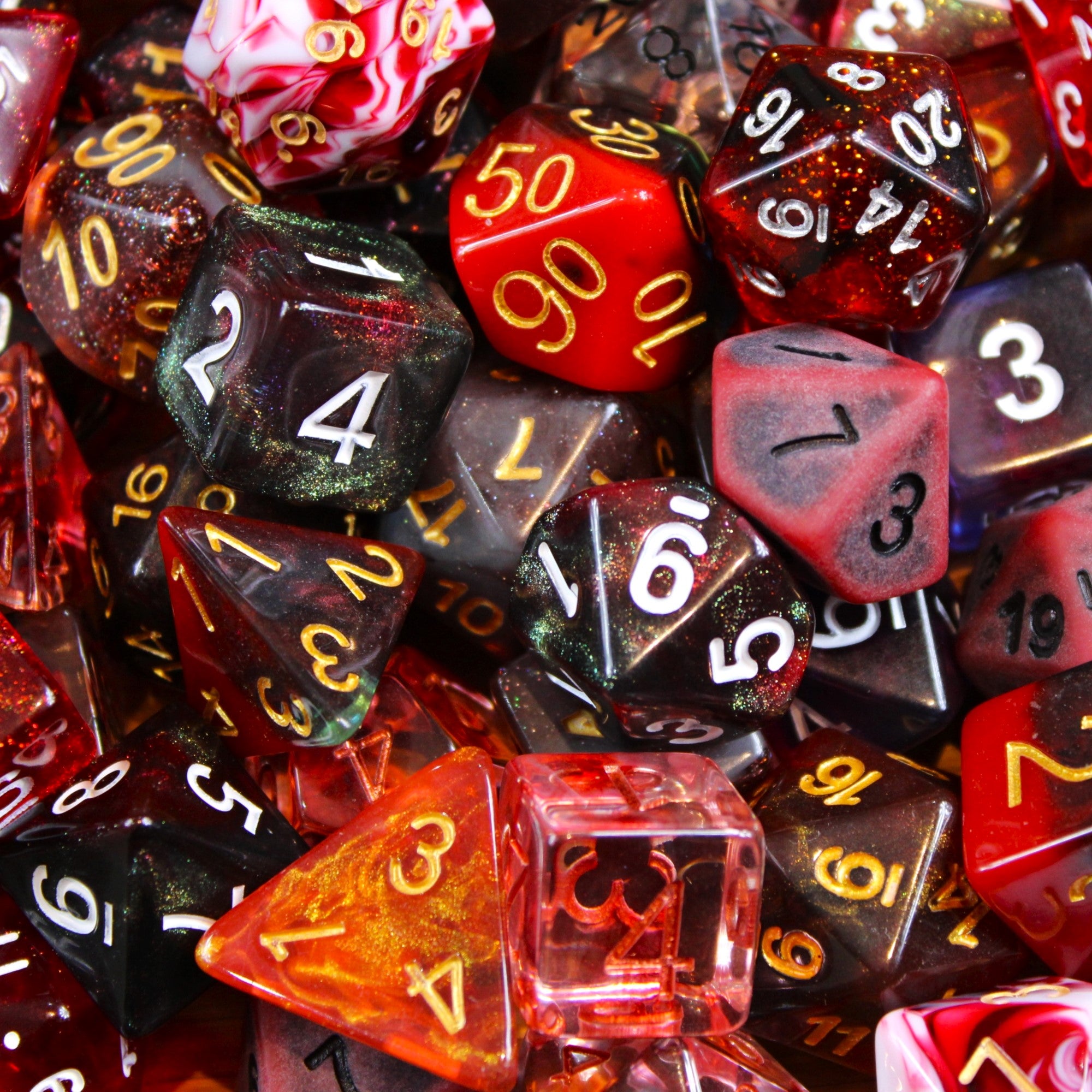 Assorted solid, clear and glitter red polyhedral roleplaying dice with numbers on a close-up shot