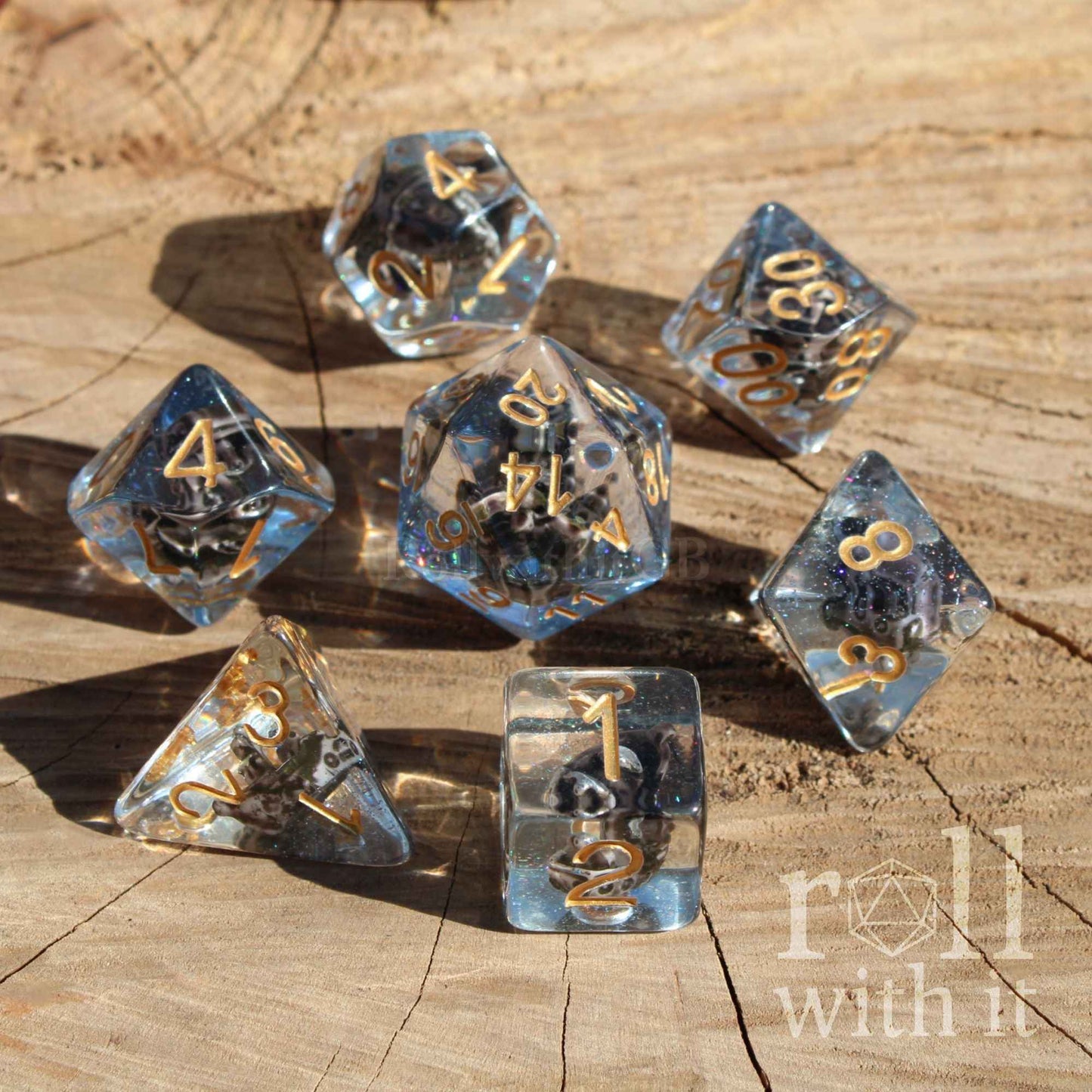Clear dice with a ocean blue layer and a pirate ship on a wooden surface