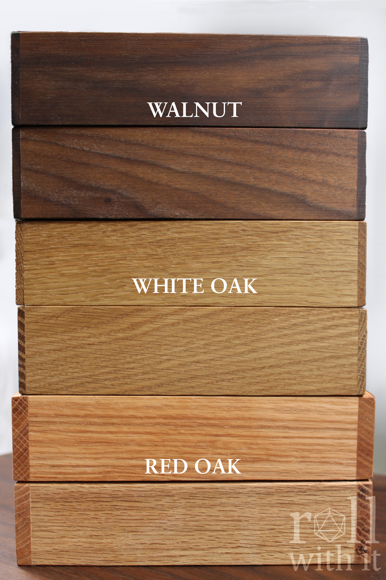 Stack of wooden roleplaying tabletop dice tray boxes labeled 'Walnut', 'White Oak', and 'Red Oak' on a white background.